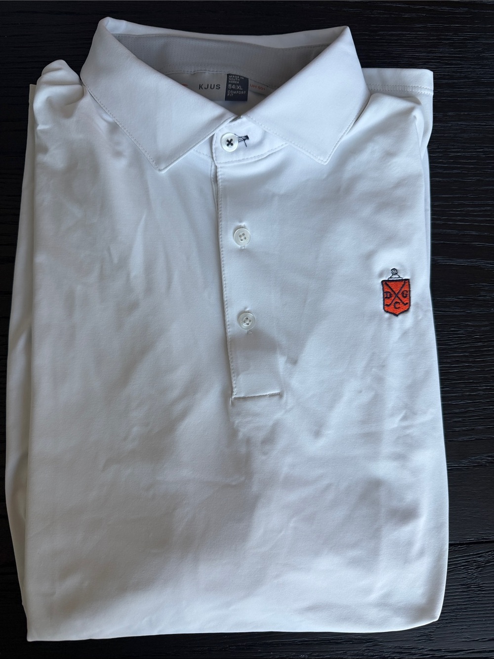 Deepdale Golf Club KJUS Men's White Polo with Orange Embroidered Crest